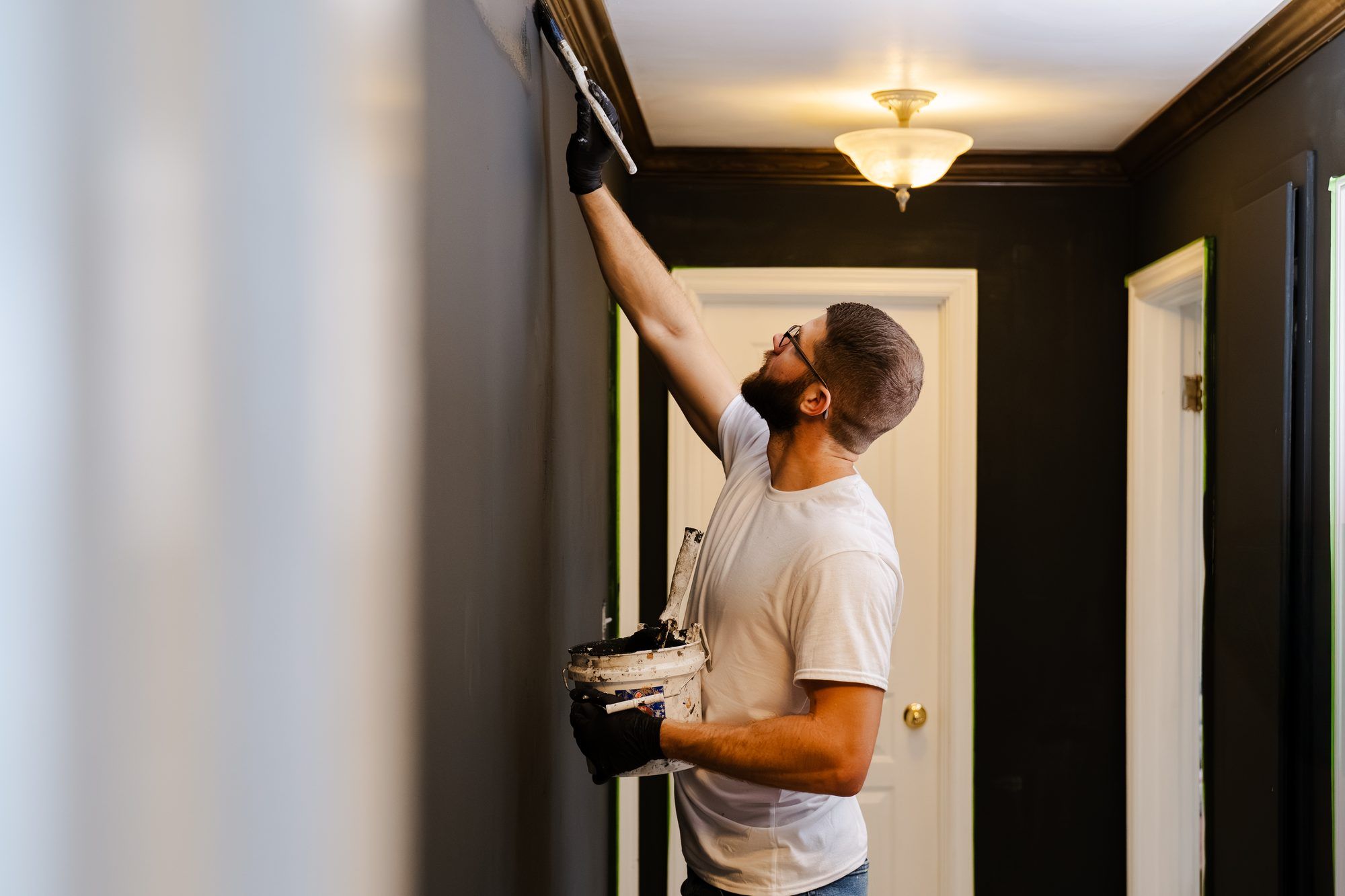 Ryan Lewis rolling a hallway wall