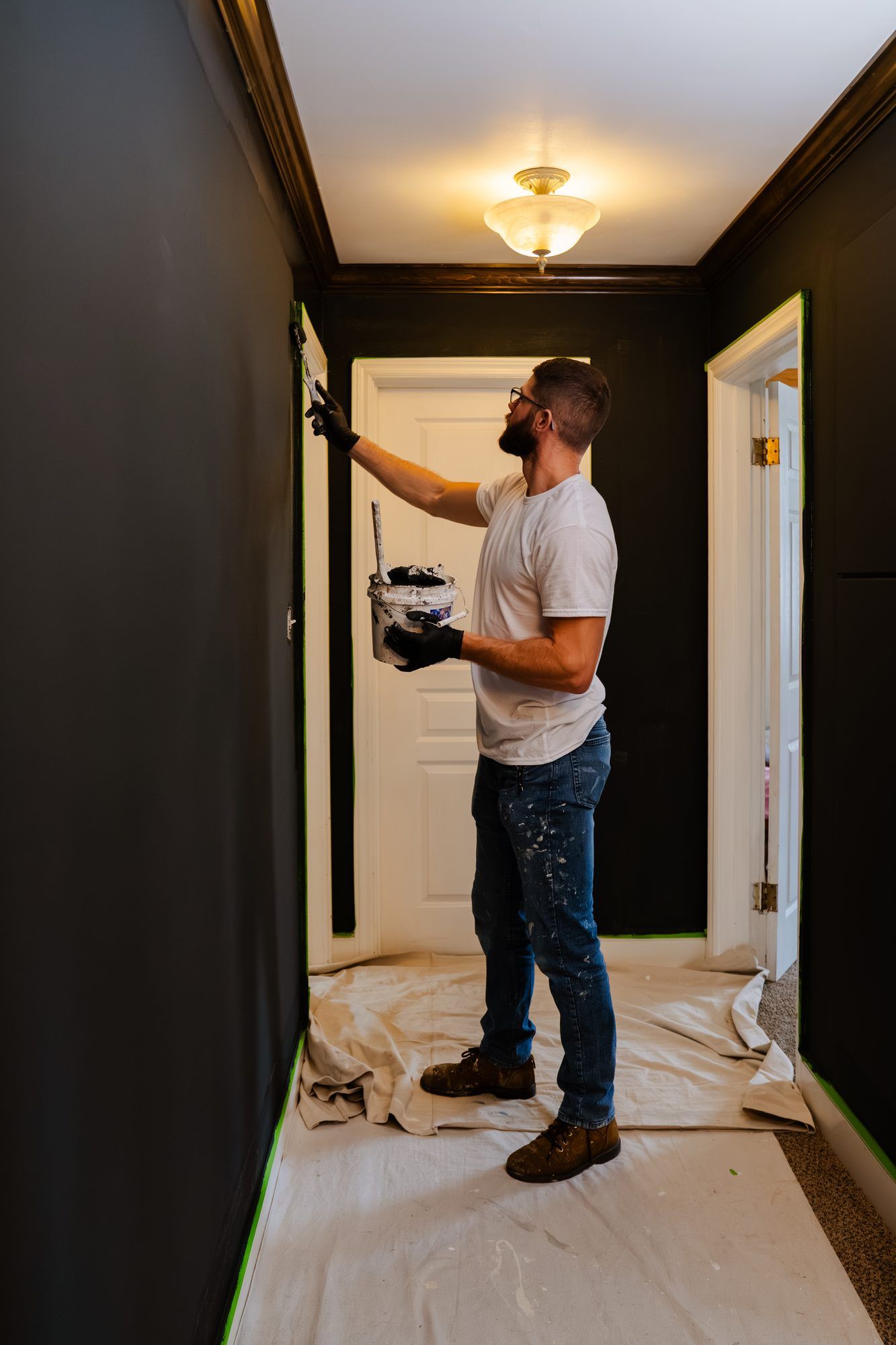 Ryan Lewis painting a hallway