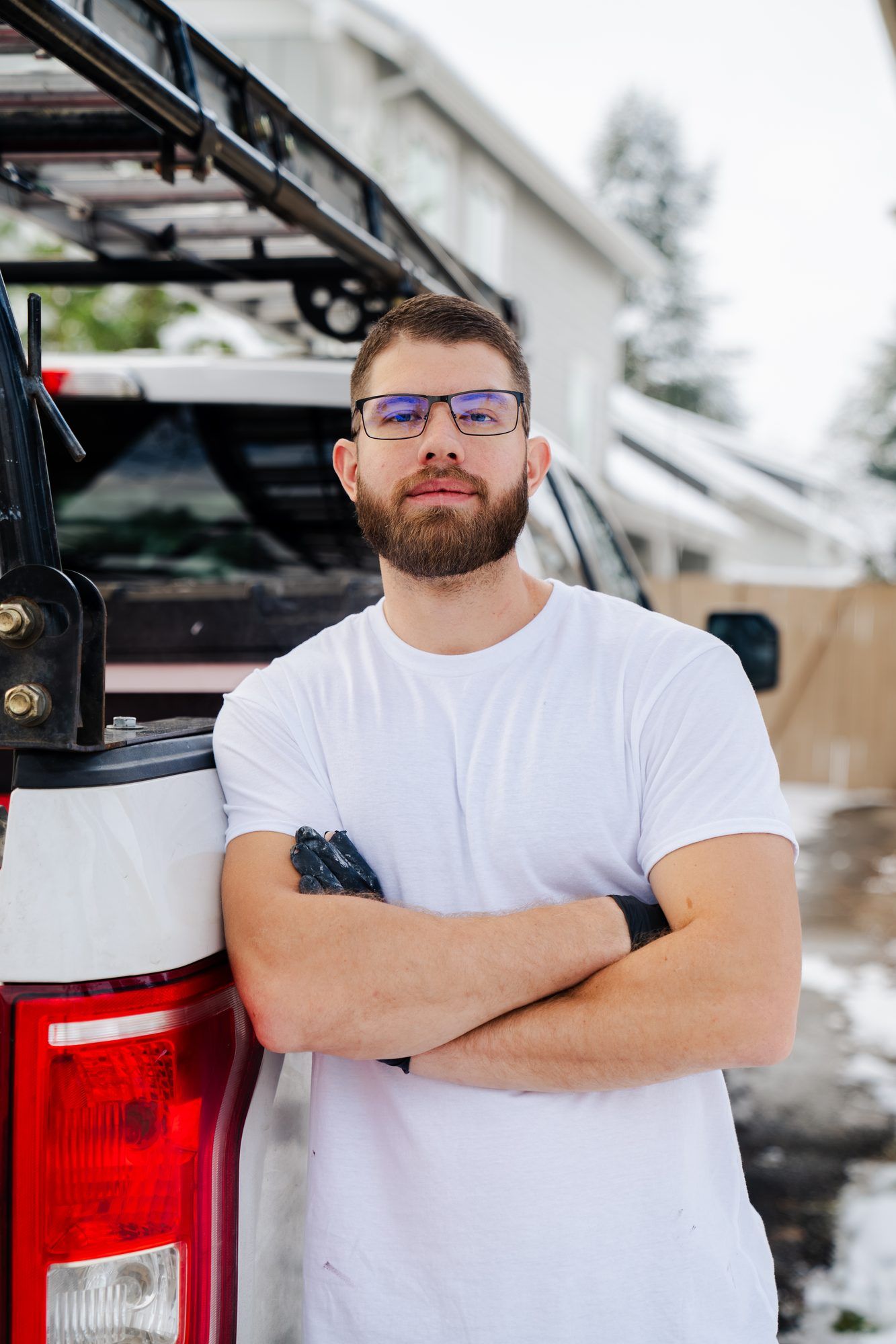 Ryan Lewis, owner of Ember Painting Co., in front of his truck